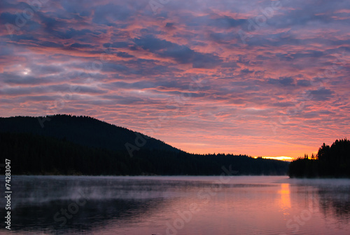 Sunset over a mountain lake in Bulgaria. © stuny