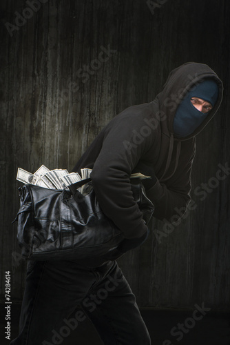 Masked theft with a big bag of stolen money