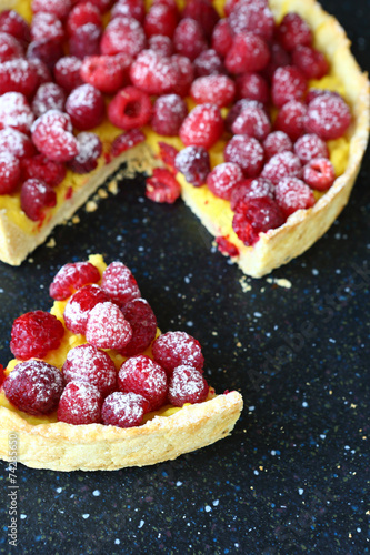 Delicious sweet pie with raspberries on a slate