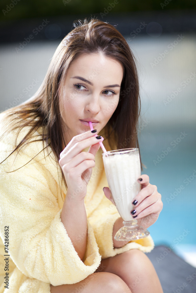 Woman with glass of cocktail enjoying wellness and spa swimming Woman with glass of cocktail enjoying wellness and spa swimming