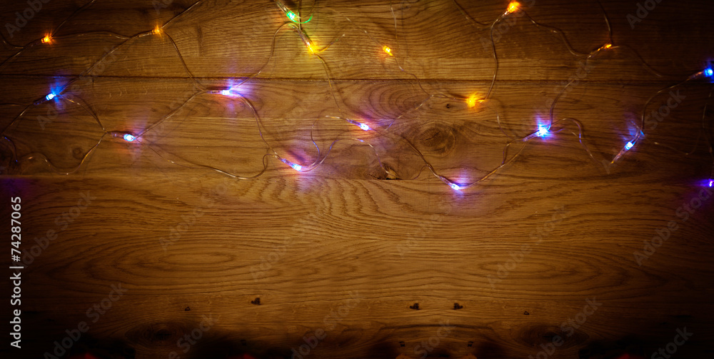 Christmas lights on wooden background Christmas lights on wooden background