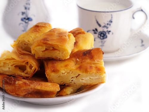 Homemade cheese strudel and cup of milk photo