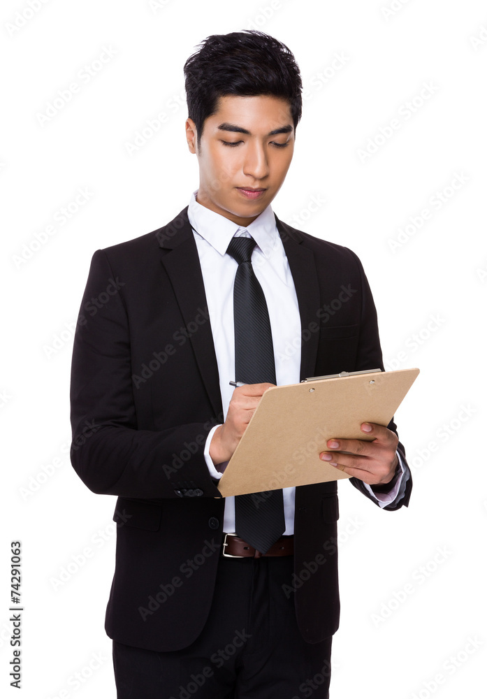 Businessman write on clipboard Businessman write on clipboard