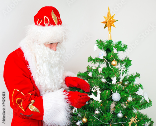 Wallpaper Mural Santa Claus decorates the Christmas tree. Torontodigital.ca