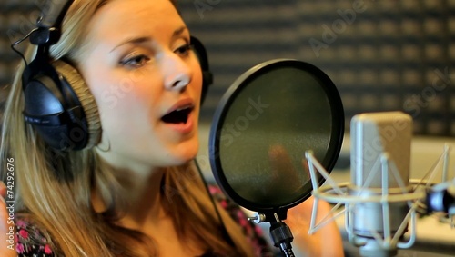 Teen girl sing at the professional audio studio. Portrait view photo