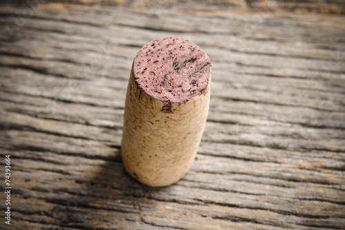 Single Wine Cork on Rustic Wood Background