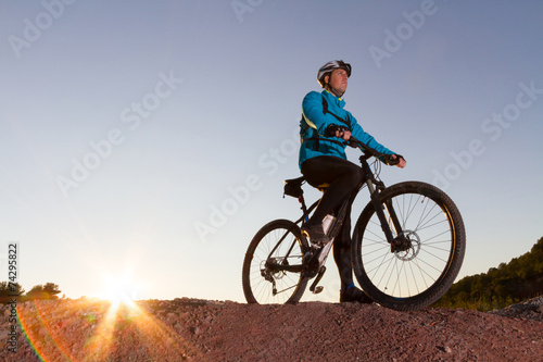 Cyclist with mountain bike on top