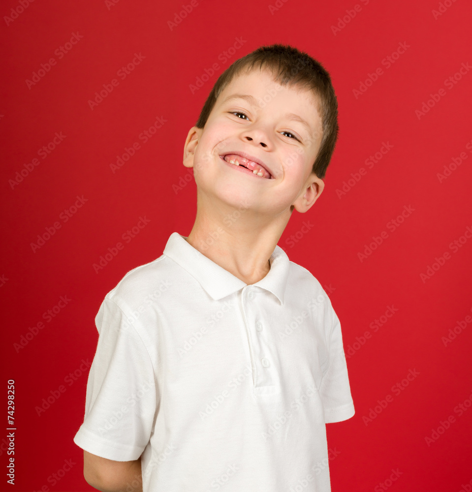 grimacing boy portrait on red grimacing boy portrait on red