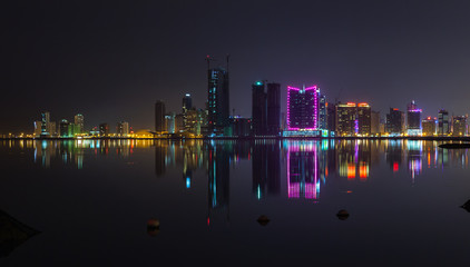 Night modern city skyline panorama with neon lights