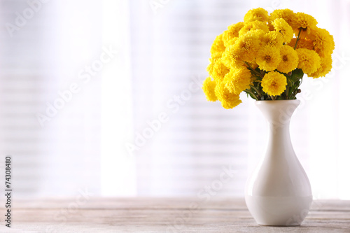 Fototapeta Naklejka Na Ścianę i Meble -  Beautiful flowers in vase with light from window