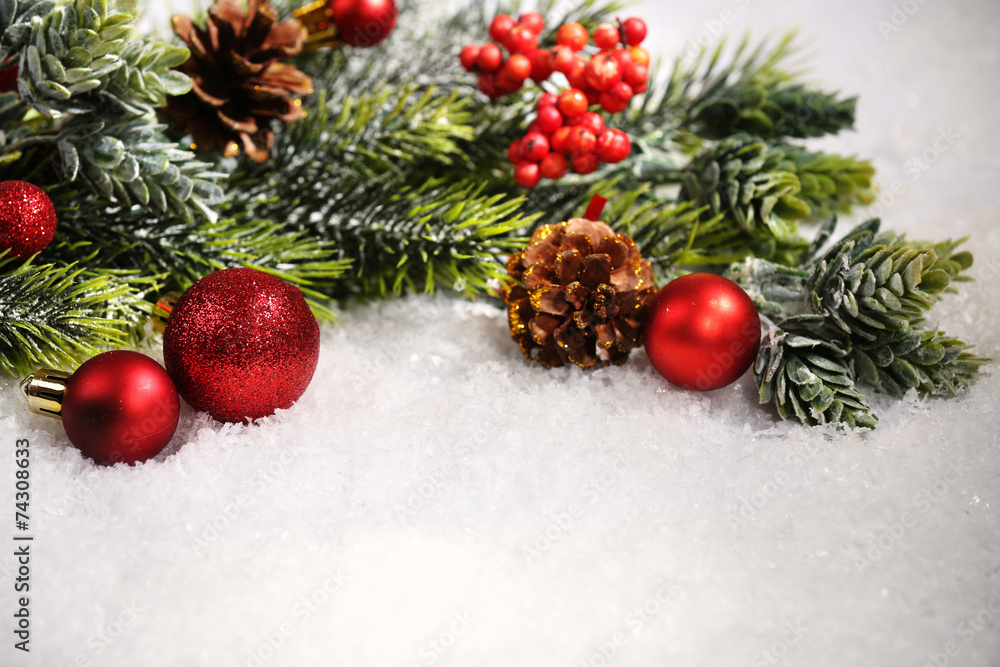 Christmas composition with baubles and fir-tree on snow Christmas composition with baubles and fir-tree on snow