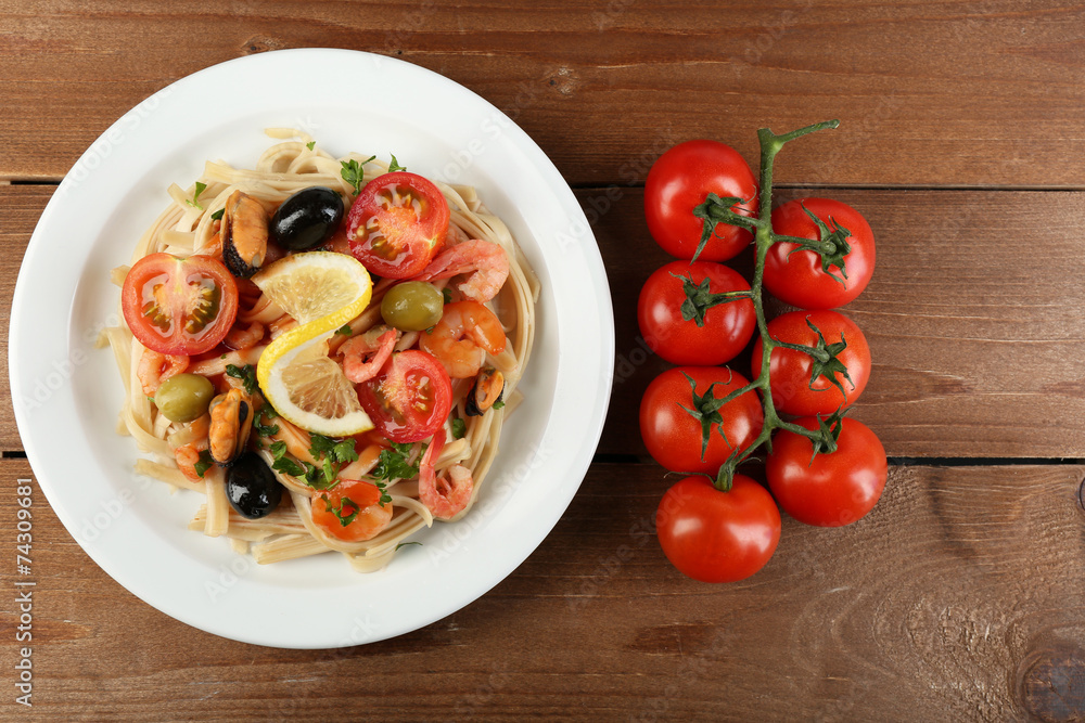 Tasty pasta with shrimps, mussels, black olives and tomato Tasty pasta with shrimps, mussels, black olives and tomato