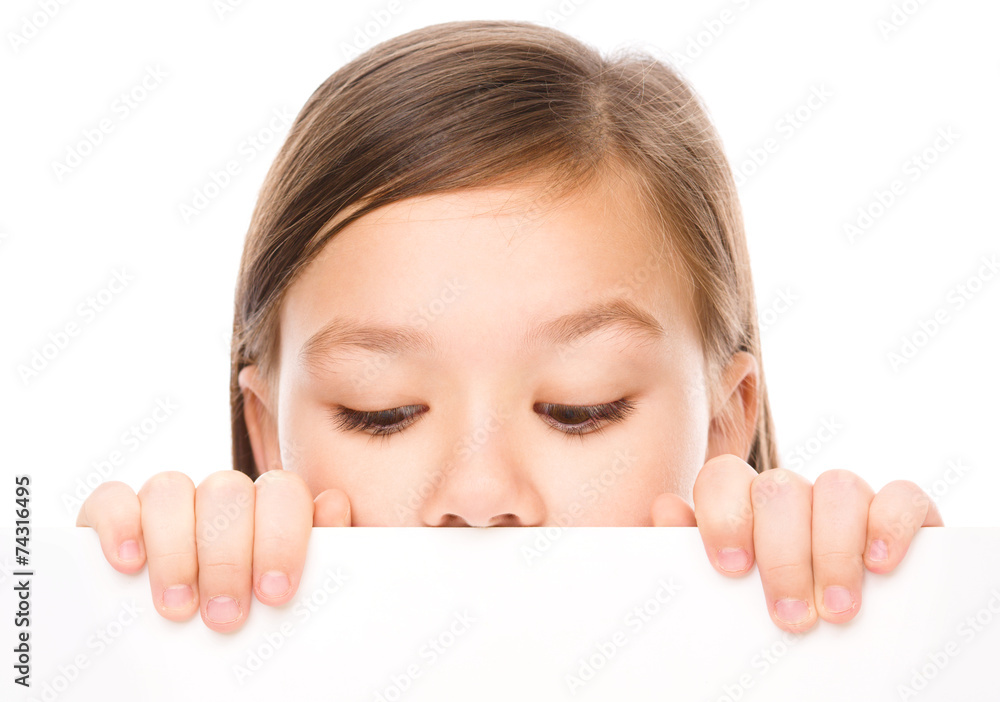 Little girl is looking from out blank board Little girl is looking from out blank board