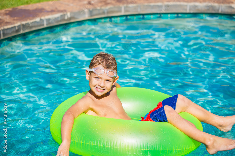 Young Kid Having Fun in the Swimming Pool