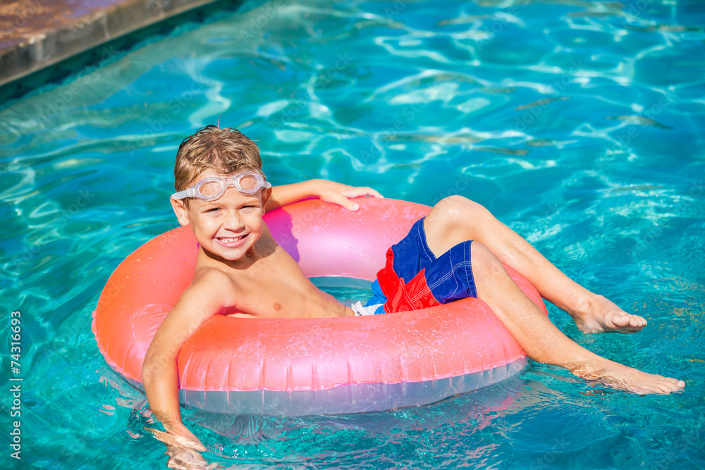 Young Kid Having Fun in the Swimming Pool