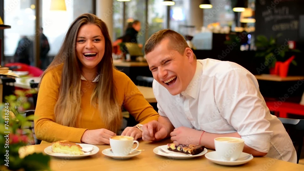 happy couple suddenly laugh in cafe - coffee and cake happy couple suddenly laugh in cafe - coffee and cake