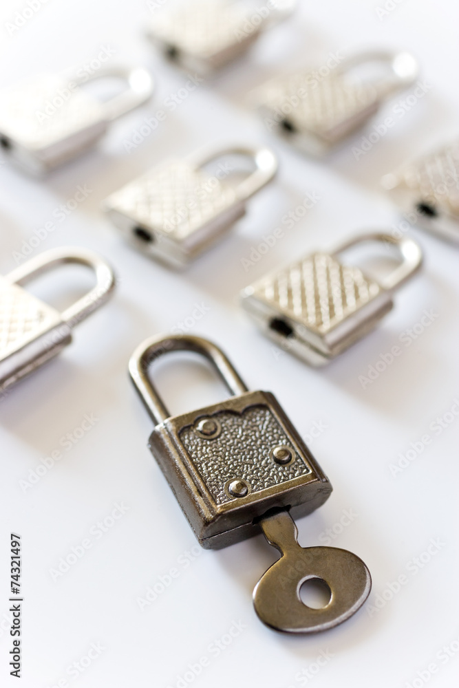 rows of padlocks on white background - lock with key inside rows of padlocks on white background - lock with key inside