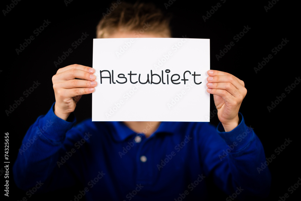 Child holding sign with Dutch word Alstublieft - Please Child holding sign with Dutch word Alstublieft - Please