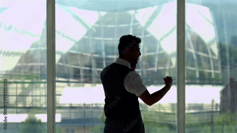 The businessman call by mobile phone by the glass attic window The businessman call by mobile phone by the glass attic window