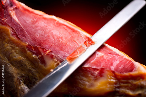 Jamon serrano. Traditional spanish ham. Slicing hamon iberico