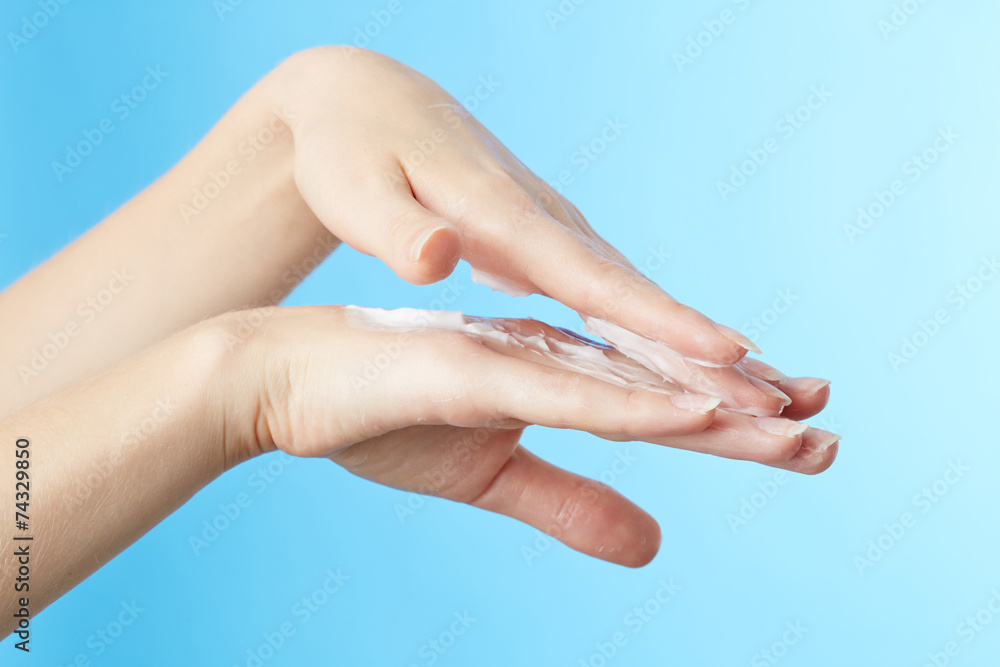 Naklejka premium Woman's hands in moisturizer cream