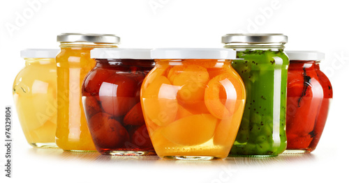 Jars with fruity compotes and jams isolated on white