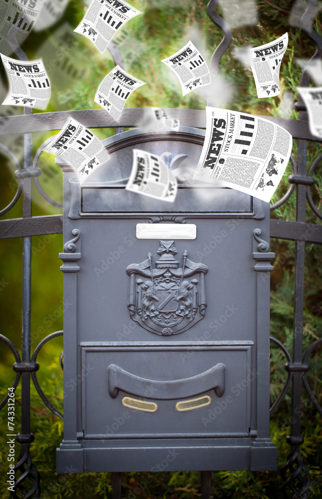 Post box with daily newspapers flying Post box with daily newspapers flying