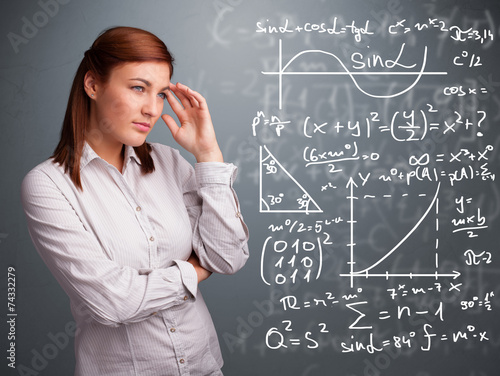 Beautiful school girl thinking about complex mathematical signs