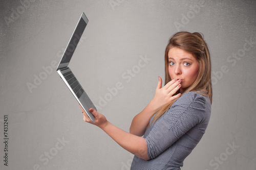 Young woman holding modern laptot photo