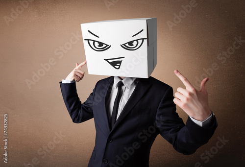 Businessman gesturing with a cardboard box on his head with evil