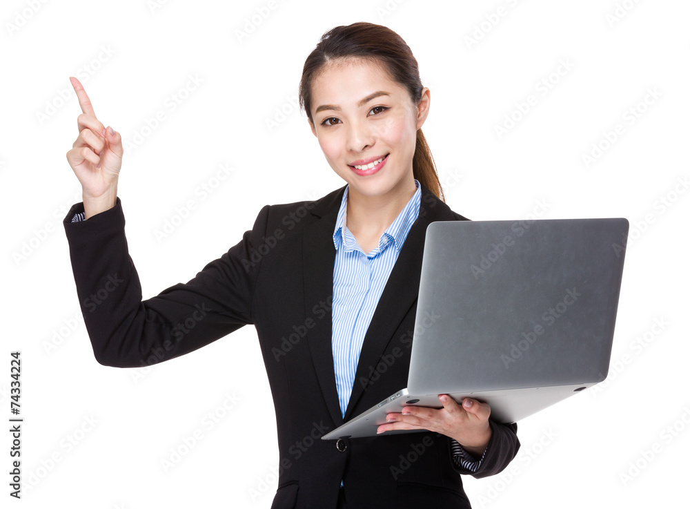 Businesswoman use of laptop and finger point up Businesswoman use of laptop and finger point up