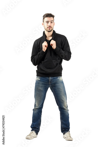 Male fashion model pulling hoodie laces