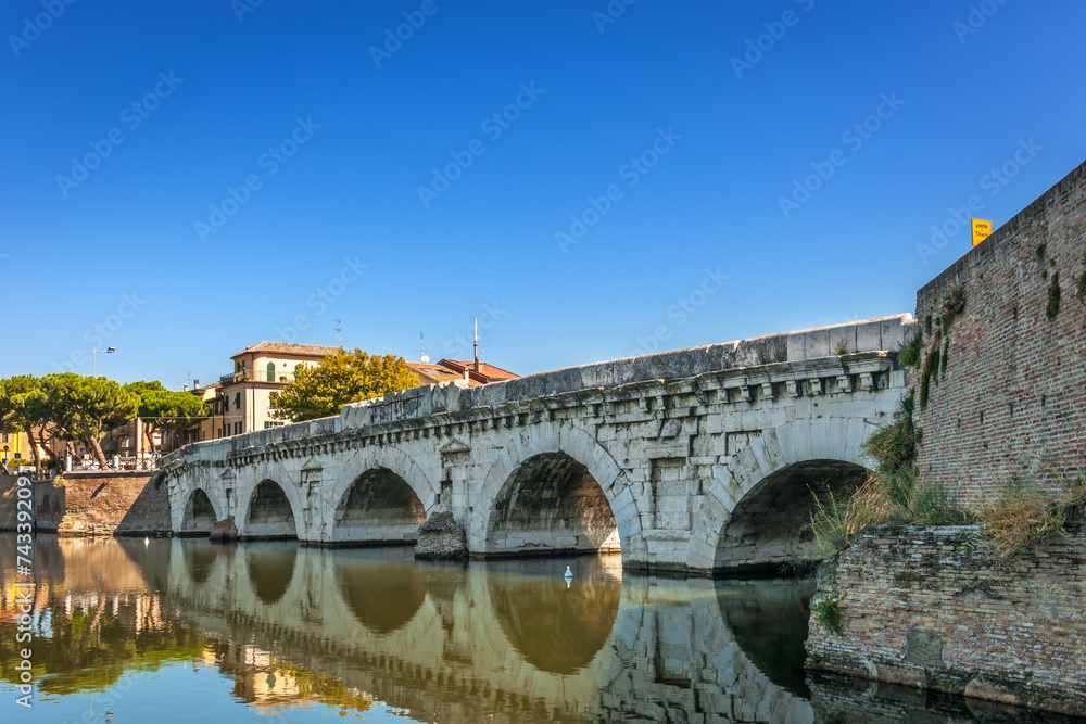 Historical roman Tiberius bridge over Marecchia river in Rimini