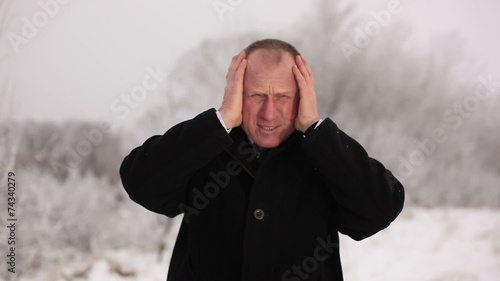 businessman is hurt by head. Winter photo