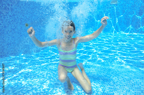 Underwater child swims in pool, girl swimming, kids sport