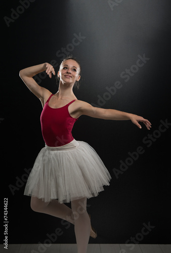 Portrait Of Beautiful Elegant Ballerina On Black Background