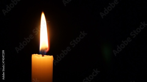 Single candle in the dark