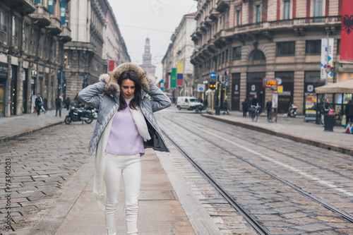 Beautiful young brunette posing in the city streets