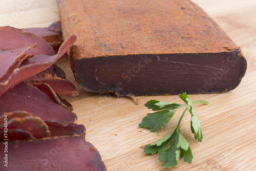 Traditional Bulgarian dried meat decorated with red pepper photo