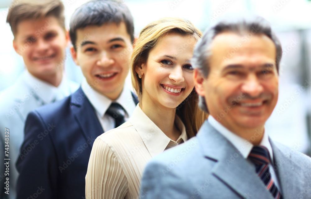 Happy smiling business team standing in a row Happy smiling business team standing in a row