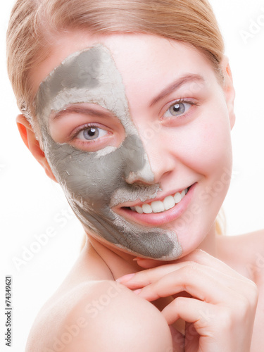 Skin care. Woman applying clay mask on face. Spa. photo