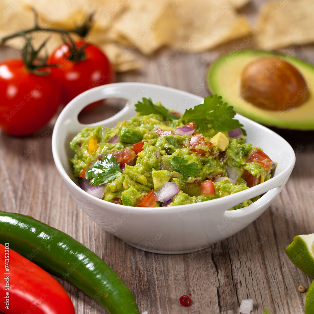 Guacamole with avocado, lime, tomato and cilantro