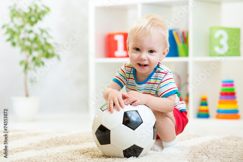 kid boy with football  indoor