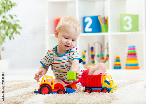 kid boy toddler playing with toy car