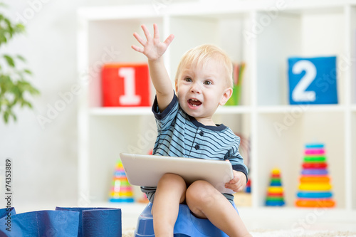 smiling child sitting on ch...