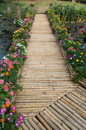 colorful flower with bamboo bridge © Suwatchai