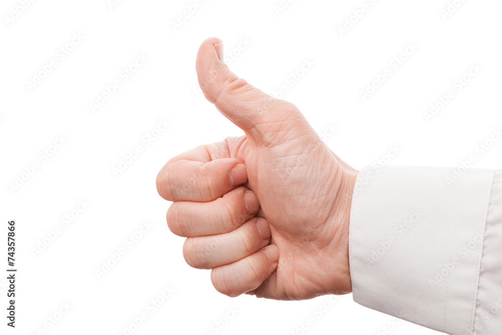 Closeup photo of male hand showing thumbs up sign Closeup photo of male hand showing thumbs up sign