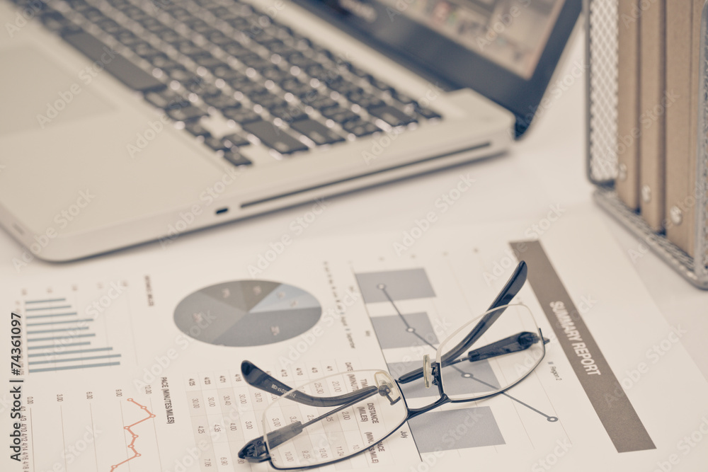 Analyzing investment charts with laptop. Accounting Analyzing investment charts with laptop. Accounting