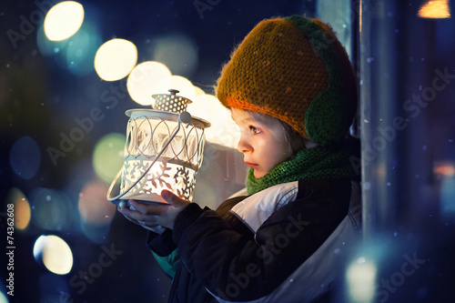 Cute boy, holding lantern outdoor