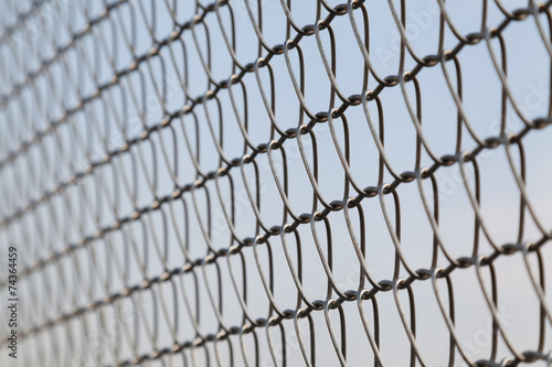 Closeup of wire mesh fence with selective focus